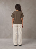 Model wearing SM Sig. Earth T-shirt in Brown, rear view.