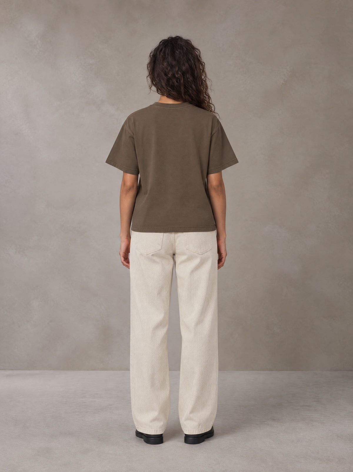 Model wearing SM Sig. Earth T-shirt in Brown, rear view.