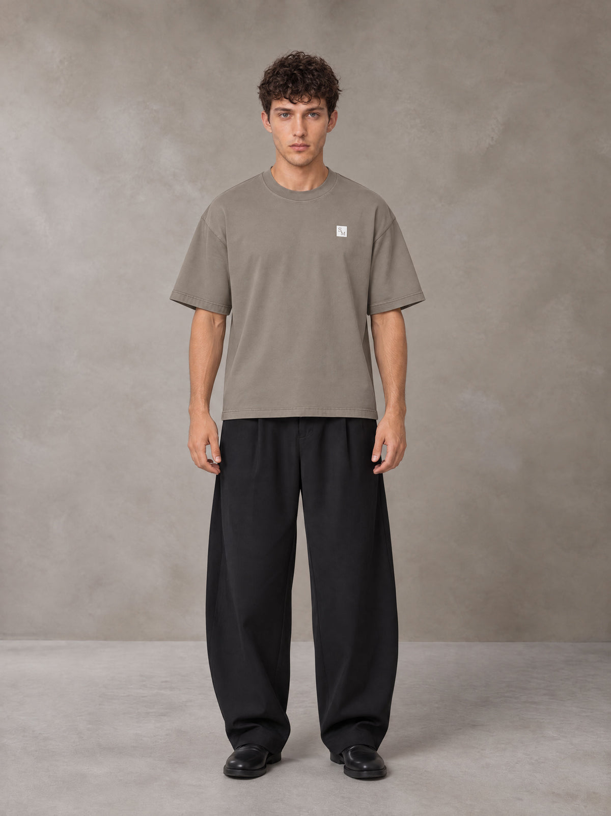 Model wearing SM Sig. Earth T-shirt in Camel Tan, front view.