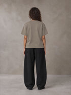 Model wearing SM Sig. Earth T-shirt in Camel Tan, rear view.