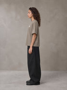 Model wearing SM Sig. Earth T-shirt in Camel Tan, side profile.