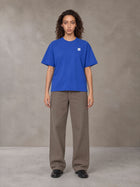Model wearing SM Sig. Earth T-shirt in Classic Blue, front view.