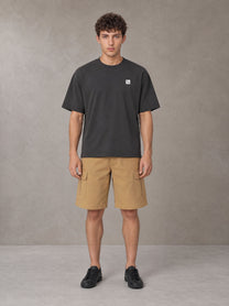 Model wearing SM Sig. Earth T-shirt in Deep Charcoal, front view.