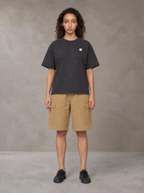Model wearing SM Sig. Earth T-shirt in Deep Charcoal, front view.