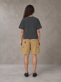 Model wearing SM Sig. Earth T-shirt in Deep Charcoal, rear view.