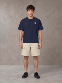 Model wearing SM Sig. Earth T-shirt in Oxford Navy, front view.
