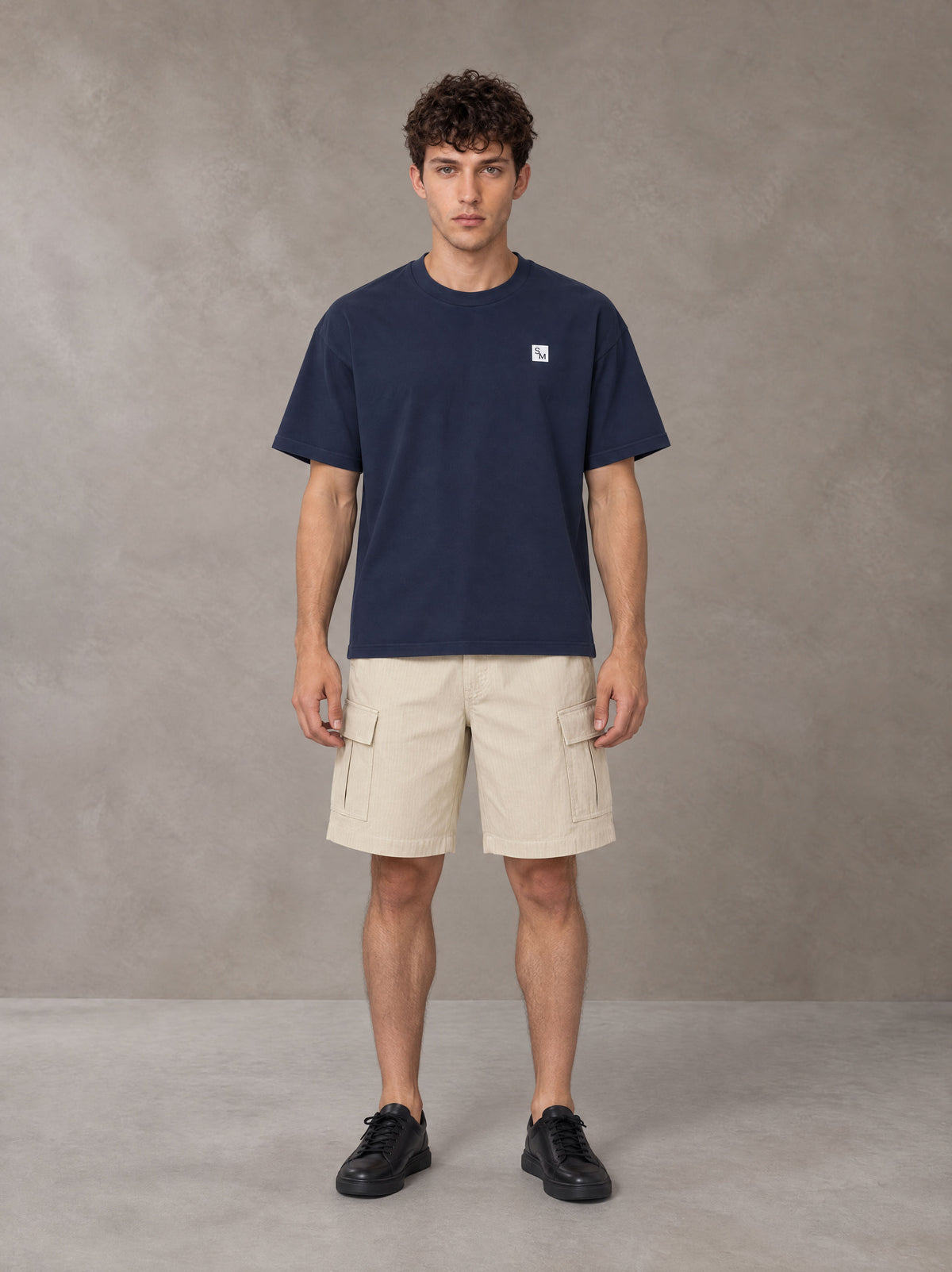 Model wearing SM Sig. Earth T-shirt in Oxford Navy, front view.