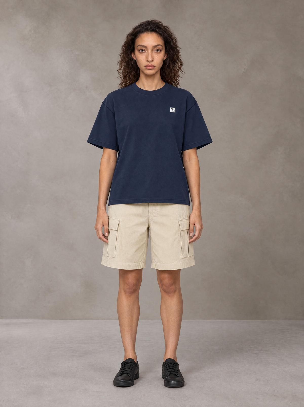 Model wearing SM Sig. Earth T-shirt in Oxford Navy, front view.
