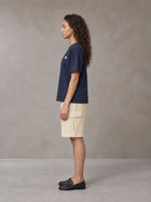 Model wearing SM Sig. Earth T-shirt in Oxford Navy, side profile.