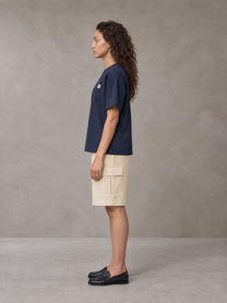 Model wearing SM Sig. Earth T-shirt in Oxford Navy, side profile.
