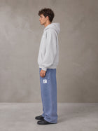 Model wearing SM Sig. Fleece Hoodie in Floral Grey, side profile.