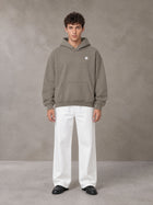 Model wearing SM Sig. Fleece Hoodie in Coffee Grey, front view.