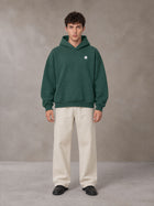 Model wearing SM Sig. Fleece Hoodie in Eden Green, front view.