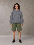 Model wearing SM Sig. Fleece Hoodie in Pure Grey, front view.