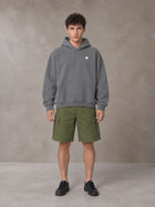 Model wearing SM Sig. Fleece Hoodie in Pure Grey, front view.