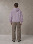 Model wearing SM Sig. Fleece Hoodie in Soft Lavender, rear view.