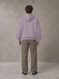 Model wearing SM Sig. Fleece Hoodie in Soft Lavender, rear view.