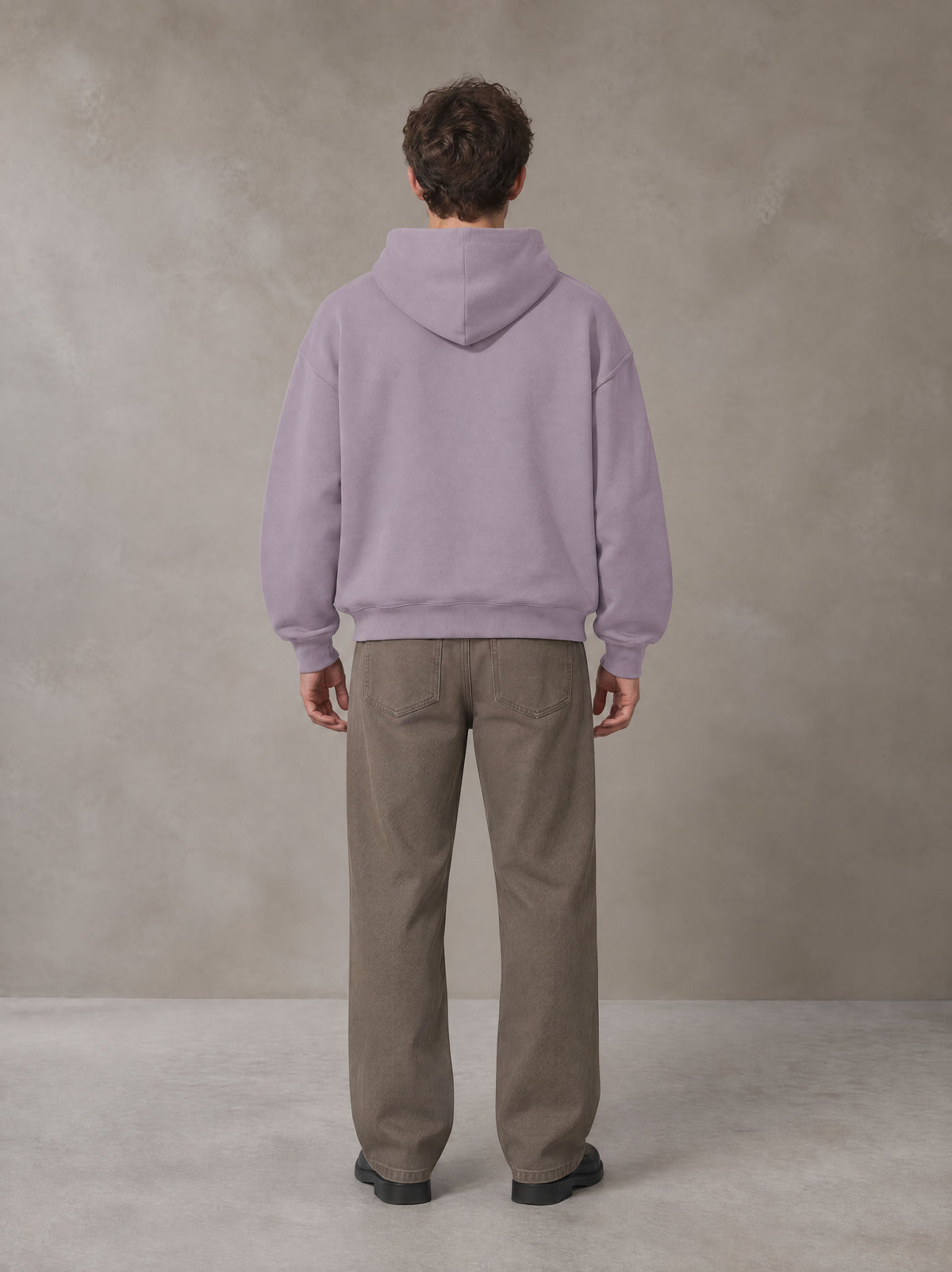 Model wearing SM Sig. Fleece Hoodie in Soft Lavender, rear view.