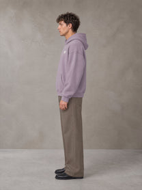 Model wearing SM Sig. Fleece Hoodie in Soft Lavender, side profile.