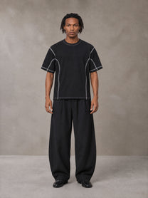 Model wearing SM Sig. Framework T-shirt in Midnight Black, front view.