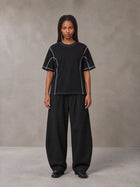 Model wearing SM Sig. Framework T-shirt in Midnight Black, front view.