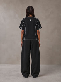Model wearing SM Sig. Framework T-shirt in Midnight Black, rear view.