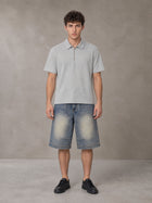 Model wearing SM Sig. Half-Zip Polo Shirt in Floral Grey, front view.