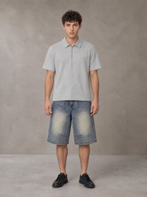 Model wearing SM Sig. Half-Zip Polo Shirt in Floral Grey, front view.