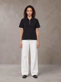 Model wearing SM Sig. Half-Zip Polo Shirt in Midnight Black, front view.
