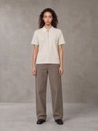 Model wearing SM Sig. Half-Zip Polo Shirt in Oatmeal Cookie, front view.