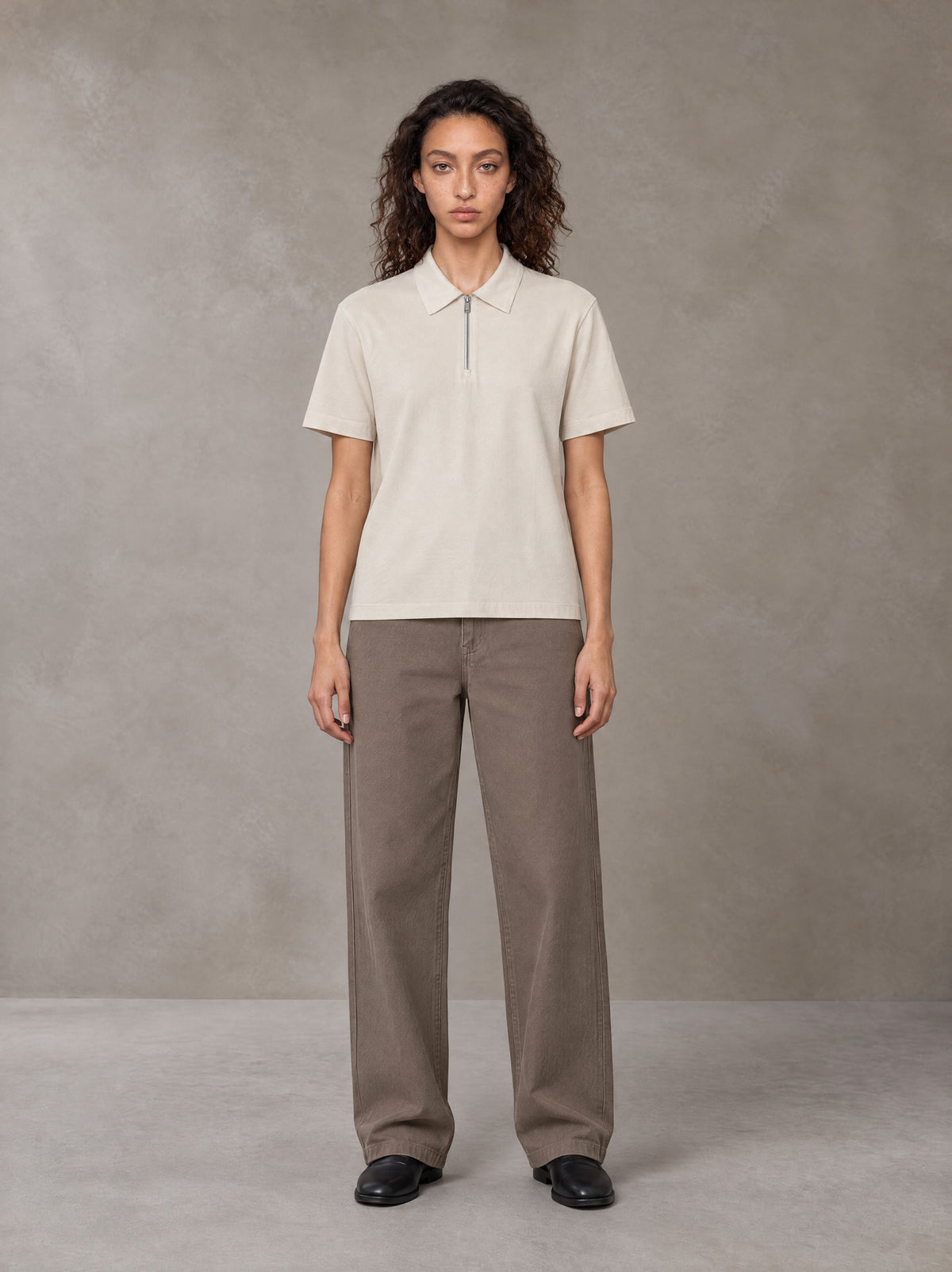 Model wearing SM Sig. Half-Zip Polo Shirt in Oatmeal Cookie, front view.