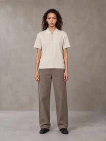Model wearing SM Sig. Half-Zip Polo Shirt in Oatmeal Cookie, front view.