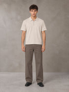 Model wearing SM Sig. Half-Zip Polo Shirt in Oatmeal Cookie, front view.