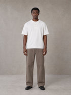 Model wearing SM Sig. Henley T-shirt in Lucent White, front view.