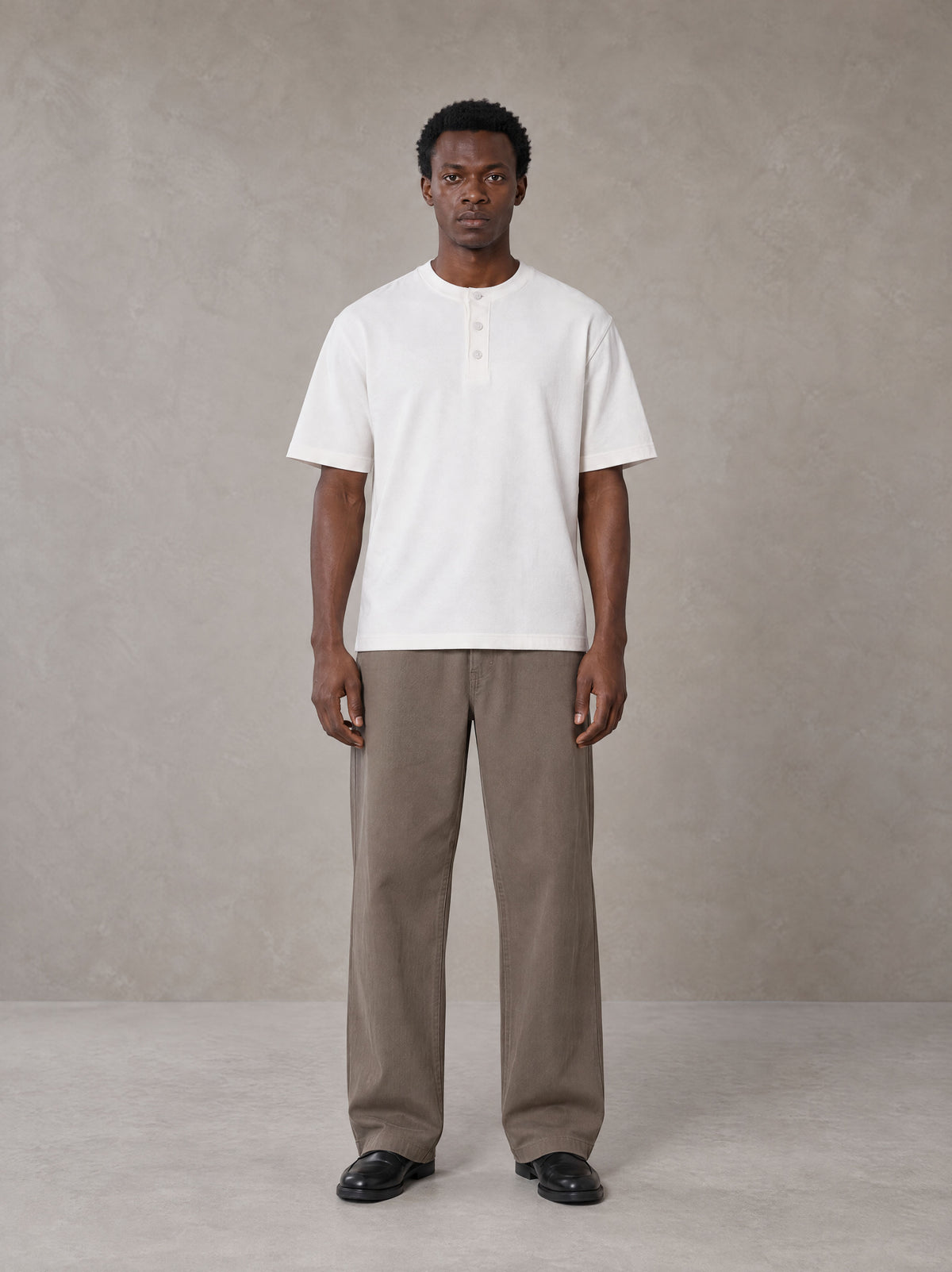 Model wearing SM Sig. Henley T-shirt in Lucent White, front view.