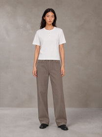 Model wearing SM Sig. Henley T-shirt in Lucent White, front view.