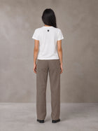 Model wearing SM Sig. Henley T-shirt in Lucent White, rear view.