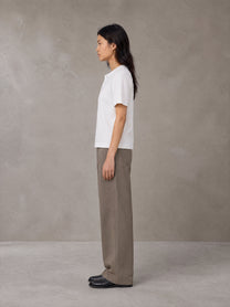 Model wearing SM Sig. Henley T-shirt in Lucent White, side profile.