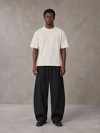 Model wearing SM Sig. Henley T-shirt in Oat Grey, front view.