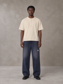 Model wearing SM Sig. Henley T-shirt in Soft Beige, front view.