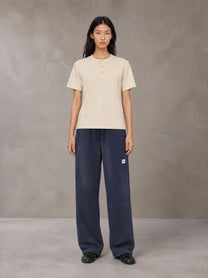 Model wearing SM Sig. Henley T-shirt in Soft Beige, front view.