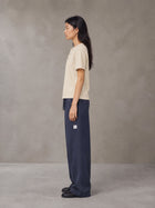 Model wearing SM Sig. Henley T-shirt in Soft Beige, side profile.