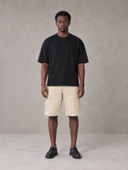 Model wearing SM Sig. Henley T-shirt in Midnight Black, front view.