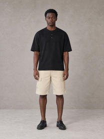 Model wearing SM Sig. Henley T-shirt in Midnight Black, front view.