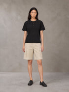 Model wearing SM Sig. Henley T-shirt in Midnight Black, front view.