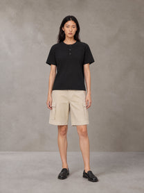 Model wearing SM Sig. Henley T-shirt in Midnight Black, front view.