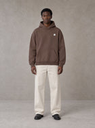 Model wearing SM Sig. High Neck Fleece Hoodie in Brown, front view.
