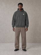 Model wearing SM Sig. High Neck Fleece Hoodie in Deep Charcoal, front view.