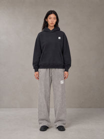 Model wearing SM Sig. High Neck Fleece Hoodie in Midnight Black, front view.