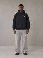 Model wearing SM Sig. High Neck Fleece Hoodie in Midnight Black, front view.